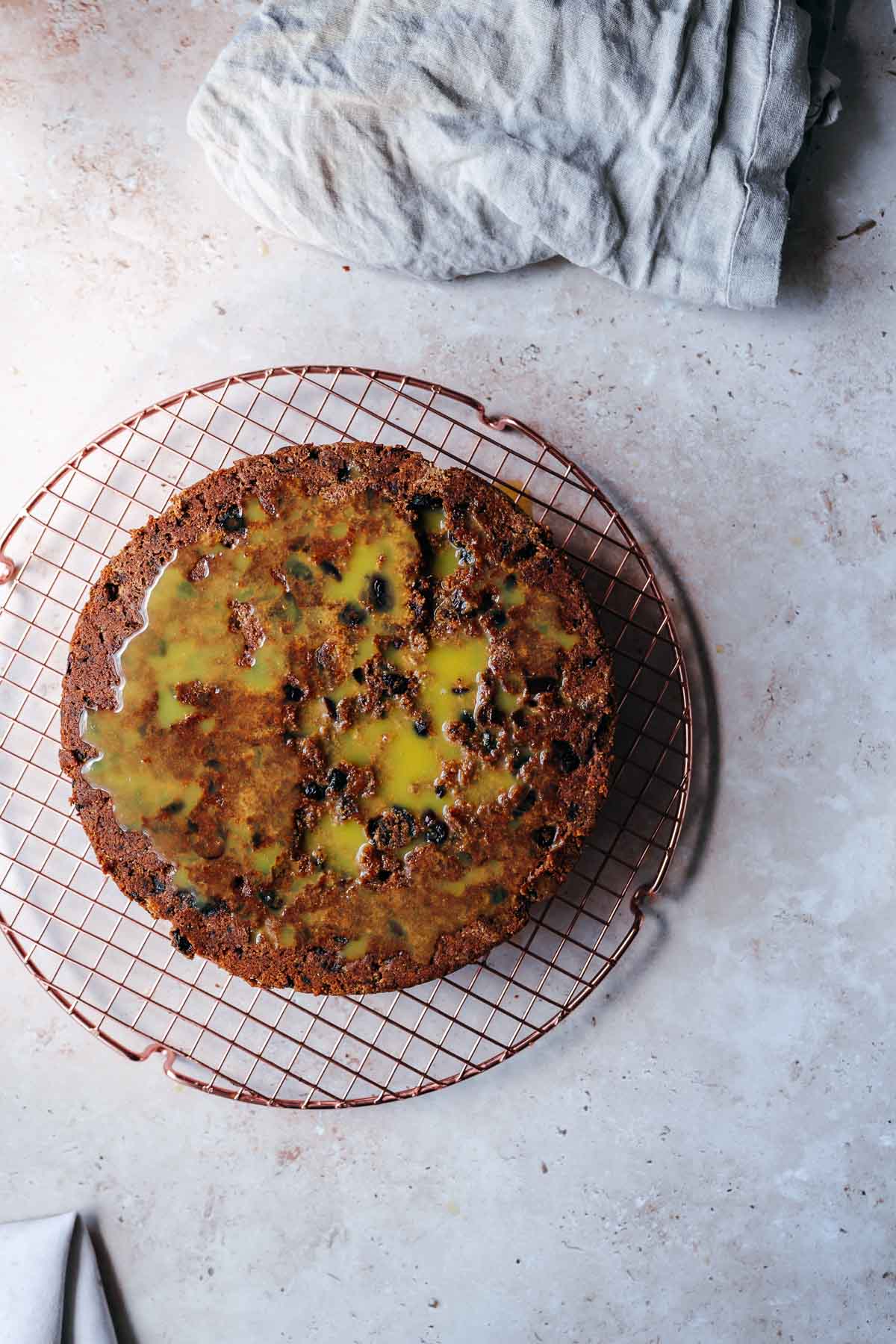 An upside down fruit cake drizzled with orange juice.