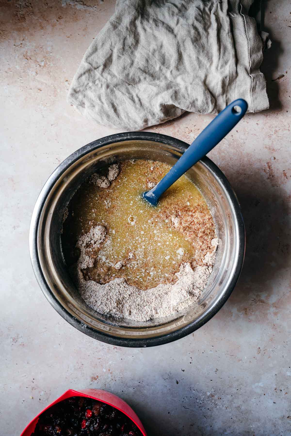 A mixing bowl filled with dry ingredients and melted butter prior to mixing.