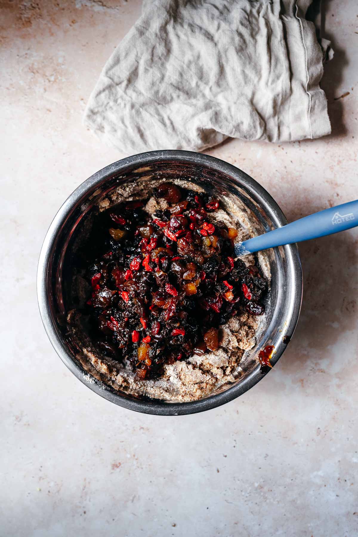 Dried fruit being mixed into a cake batter.