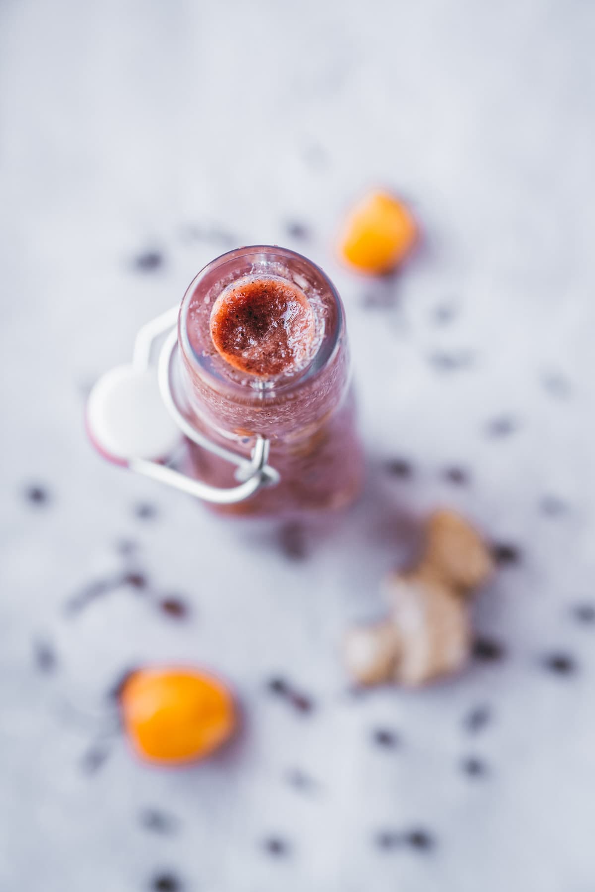 An open swing top bottle filled with homemade jerk sauce.