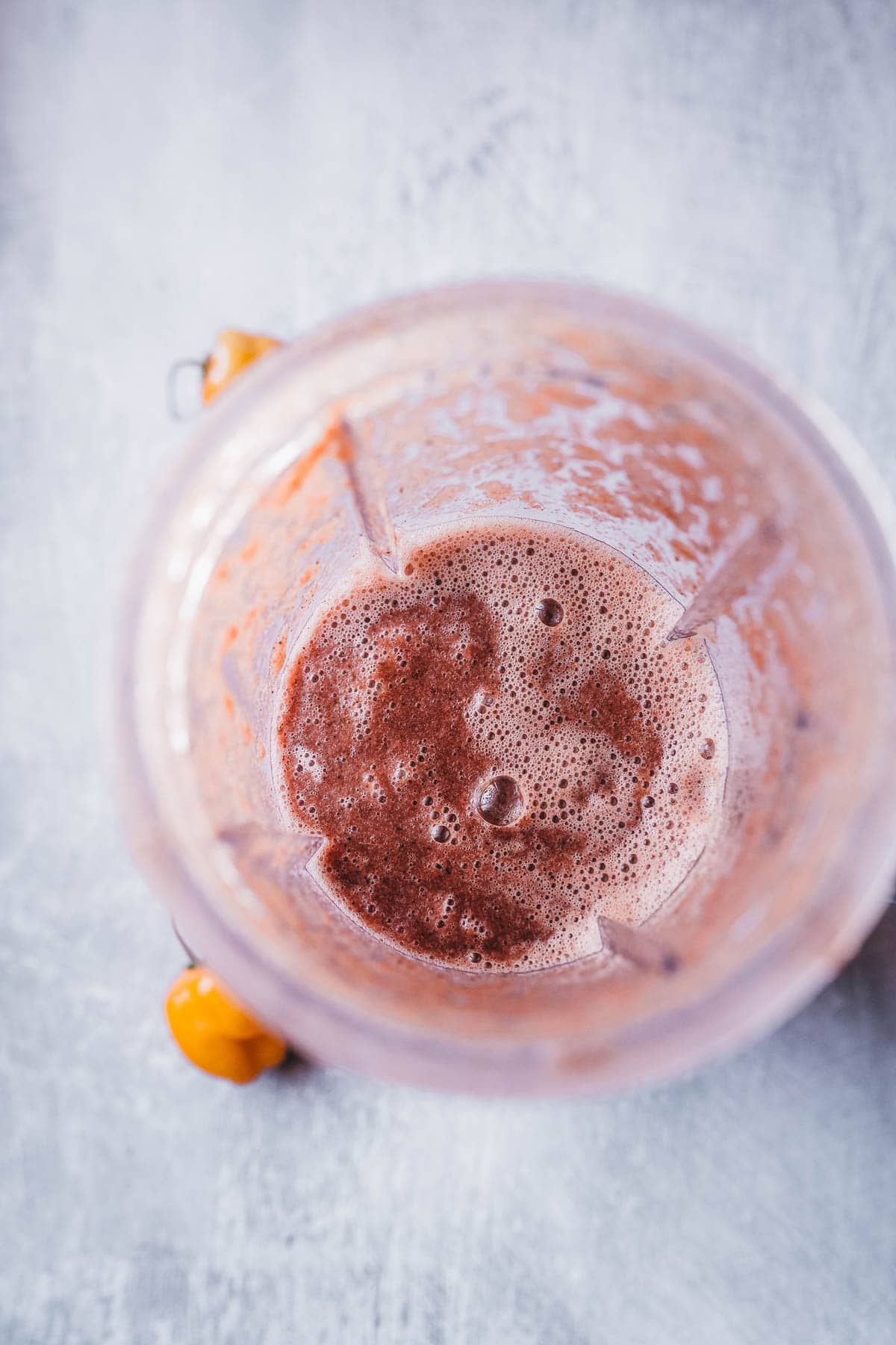 A freshly blended maroon sauce resting in an open blender container.