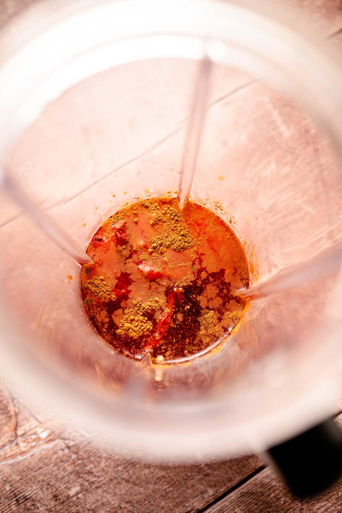 Hot sauce ingredients resting in a blender.