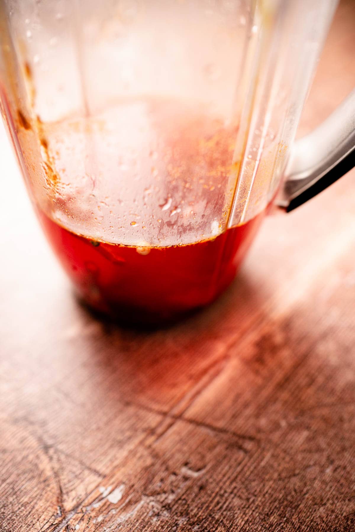 Close shot of hot sauce ingredients in a blender prior to blending.
