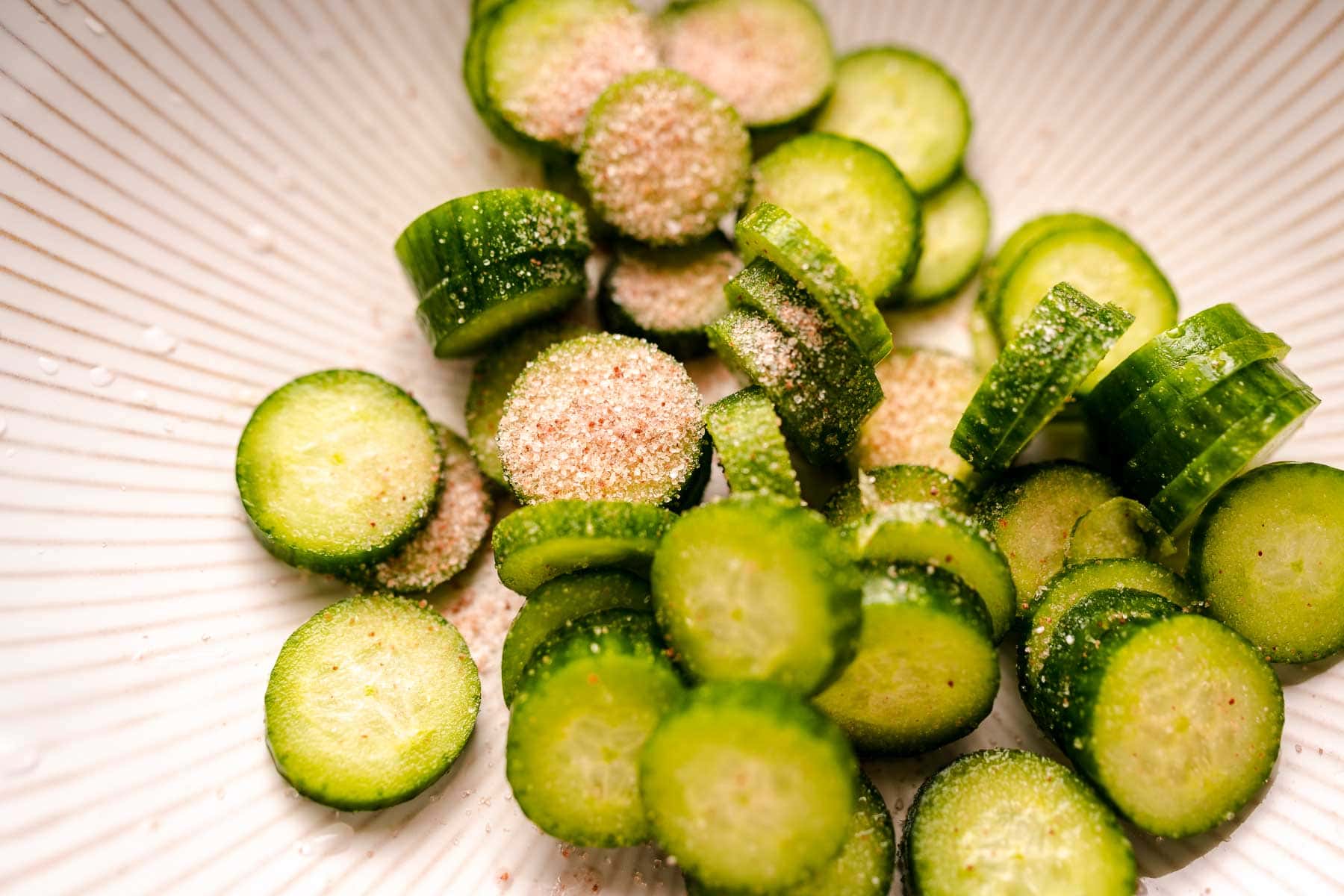 Cucumber slices topped with pink salt.