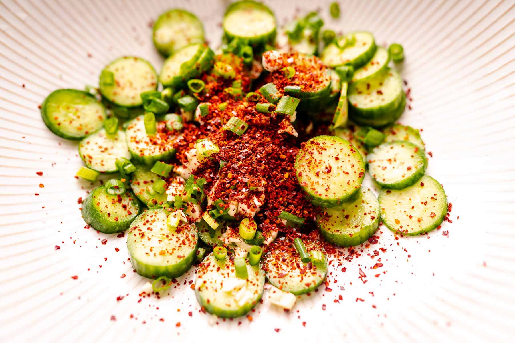 Cucumber slices topped with red pepper flakes.