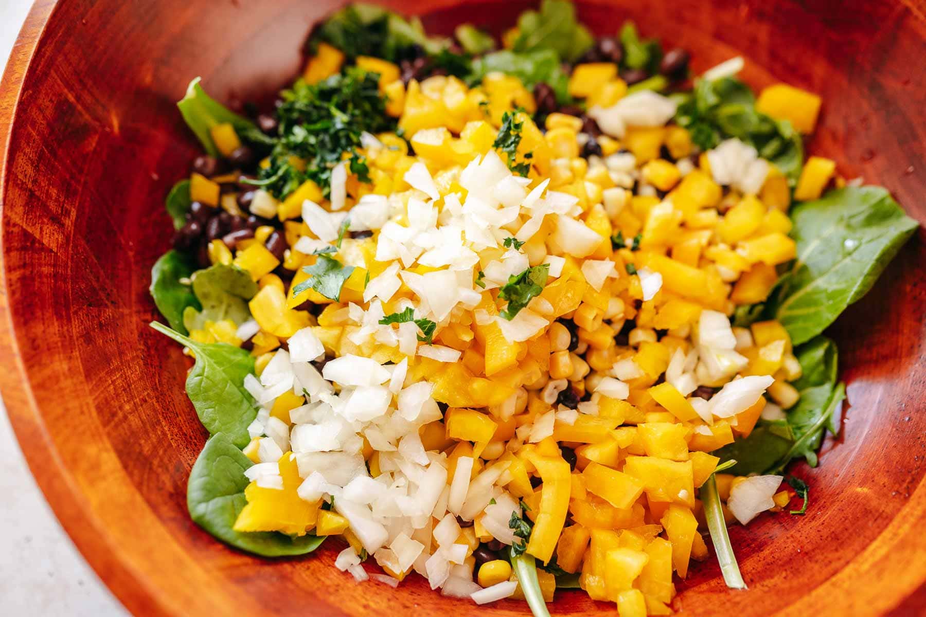 A large salad bowl filled with various salad ingredients.