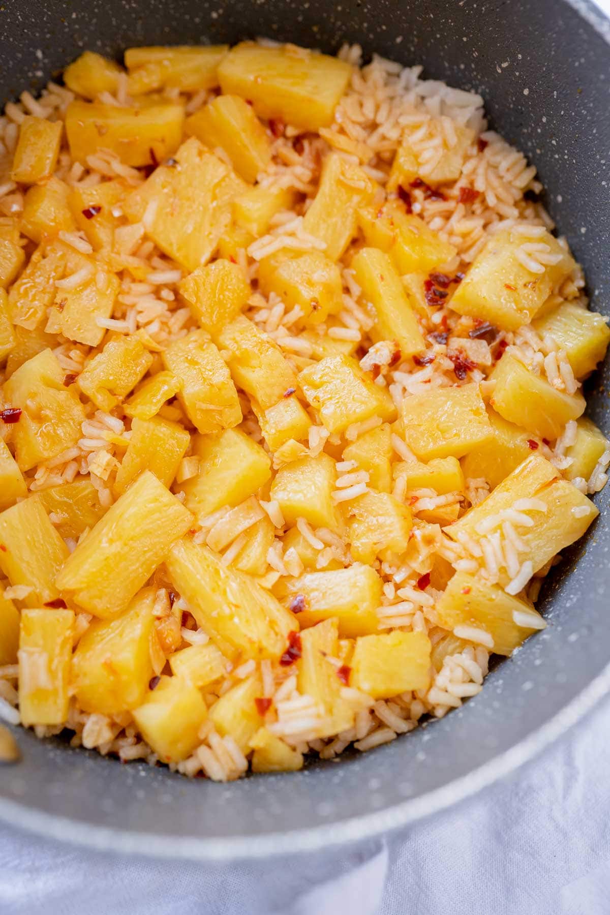 A saucepan of freshly cooked pineapple rice.
