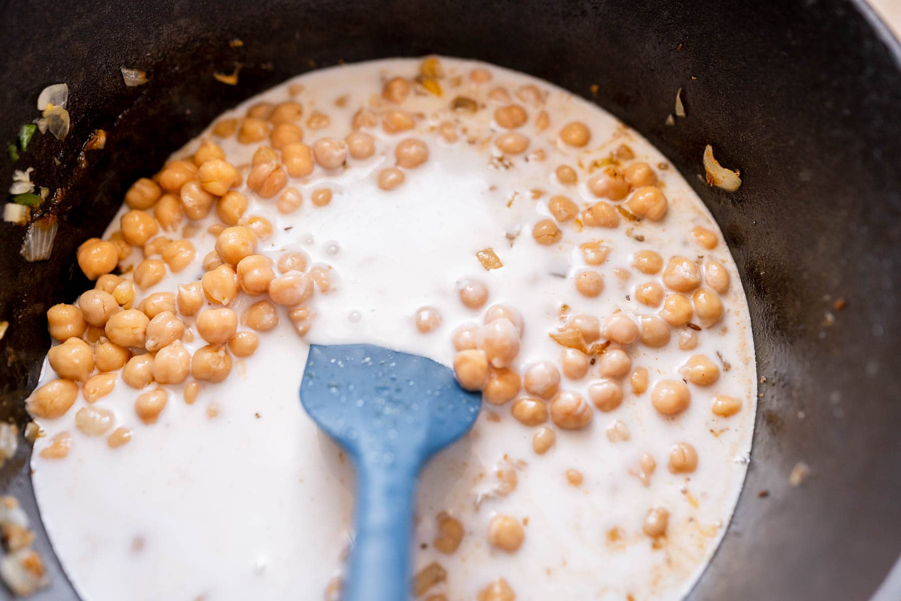 Milk and chickpeas in a large pot.