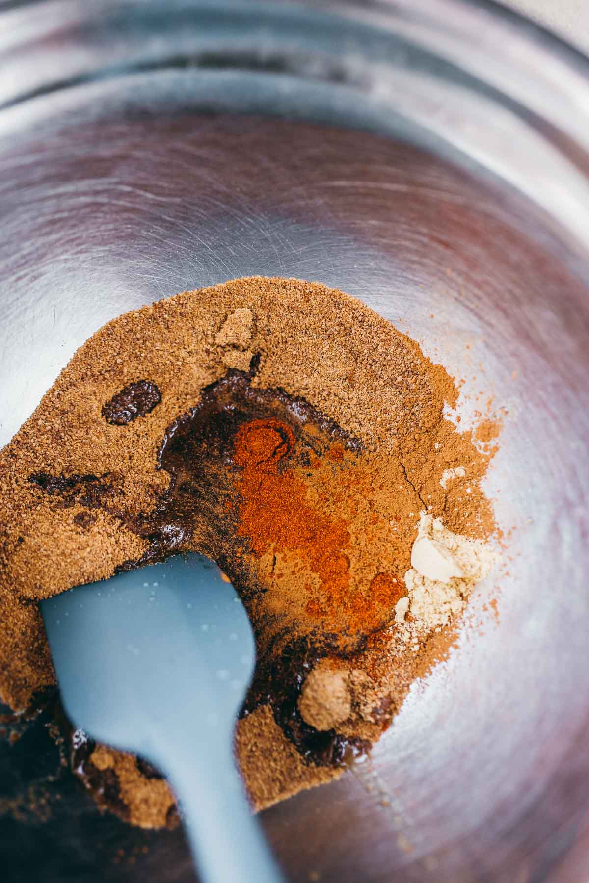 A big bowl filled with spices and maple syrup.