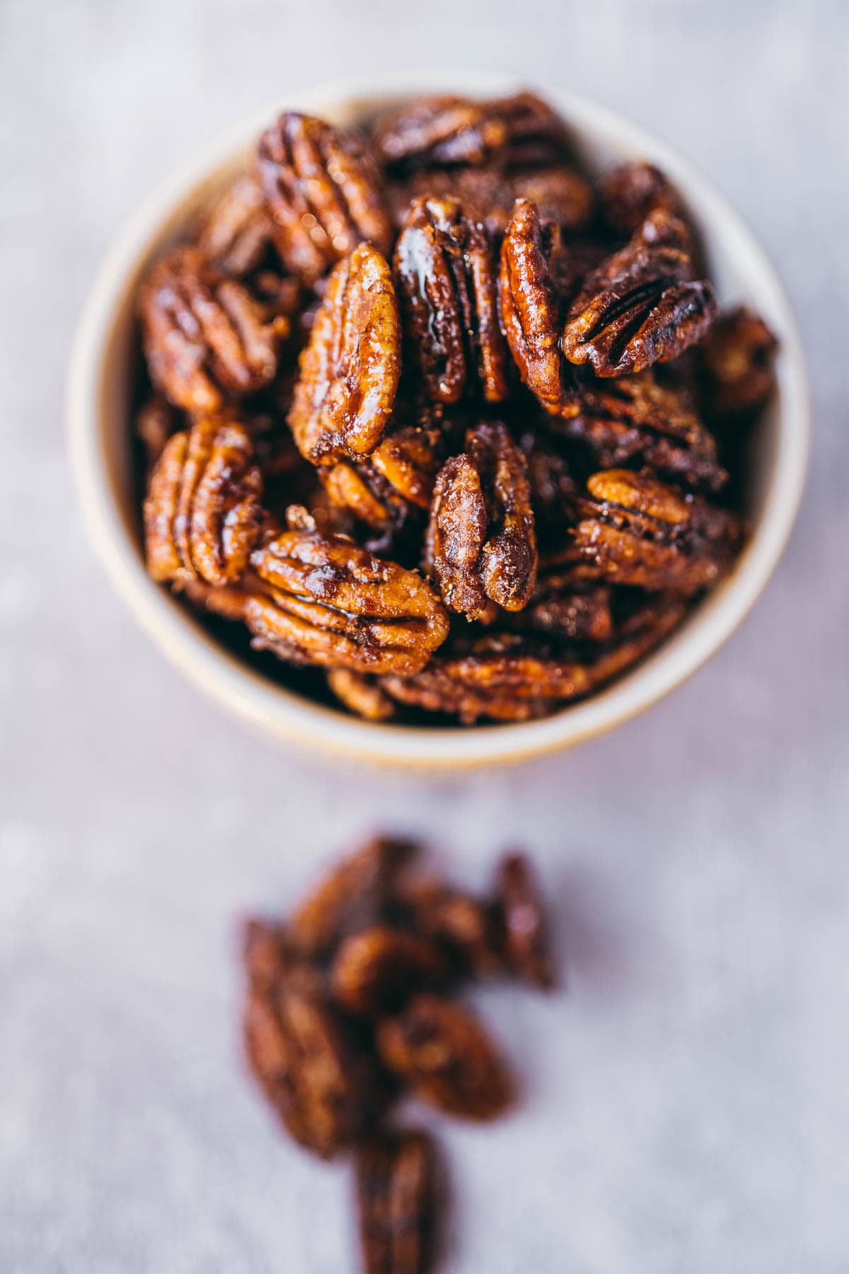 Close shot of a small bowl of spicy candied pecans.