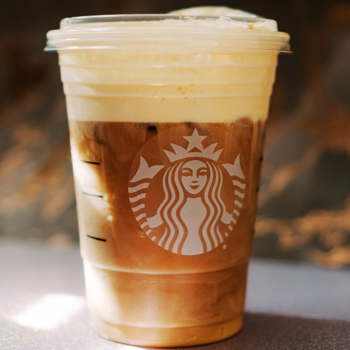 An iced Starbucks beverage in a Starbucks cup.