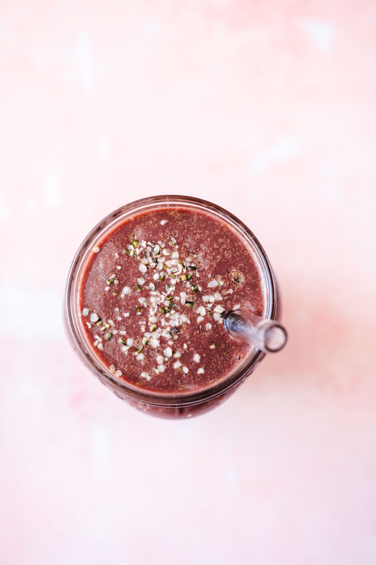 Top view of a smoothie sprinkled with hemp seeds.