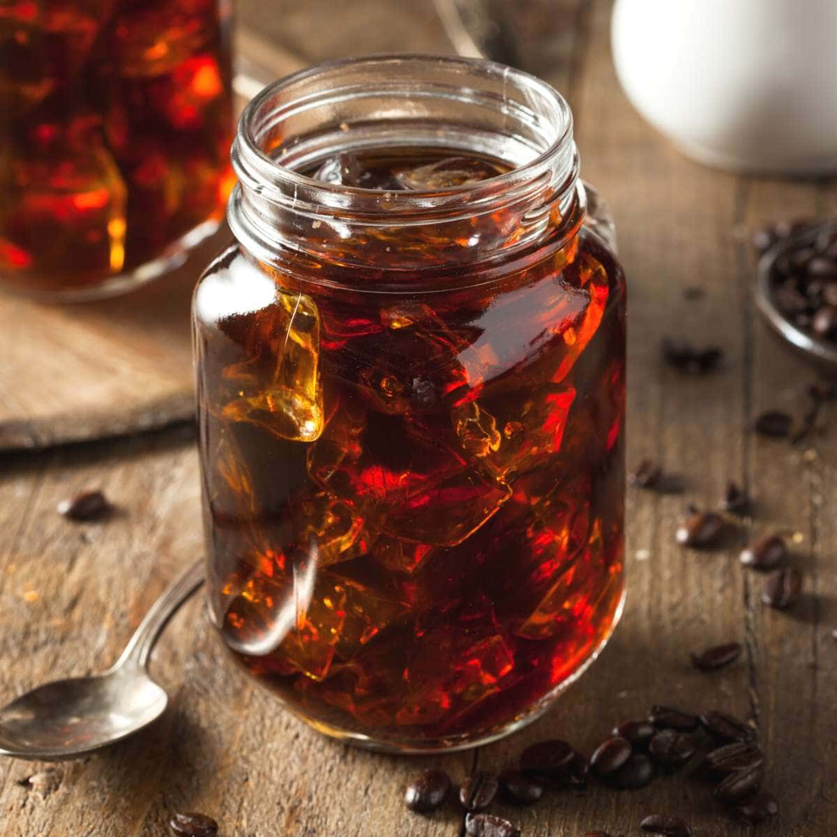 A clear mason jar glass filled with homemade cold brew.