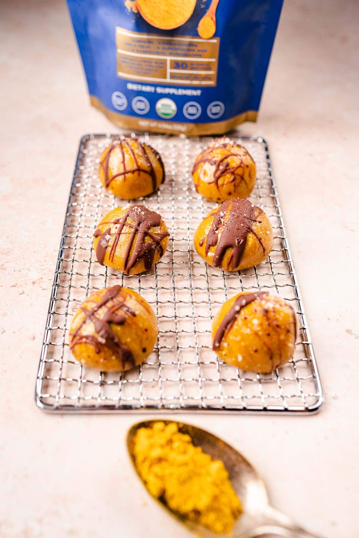 A silver rack topped with golden milk balls.