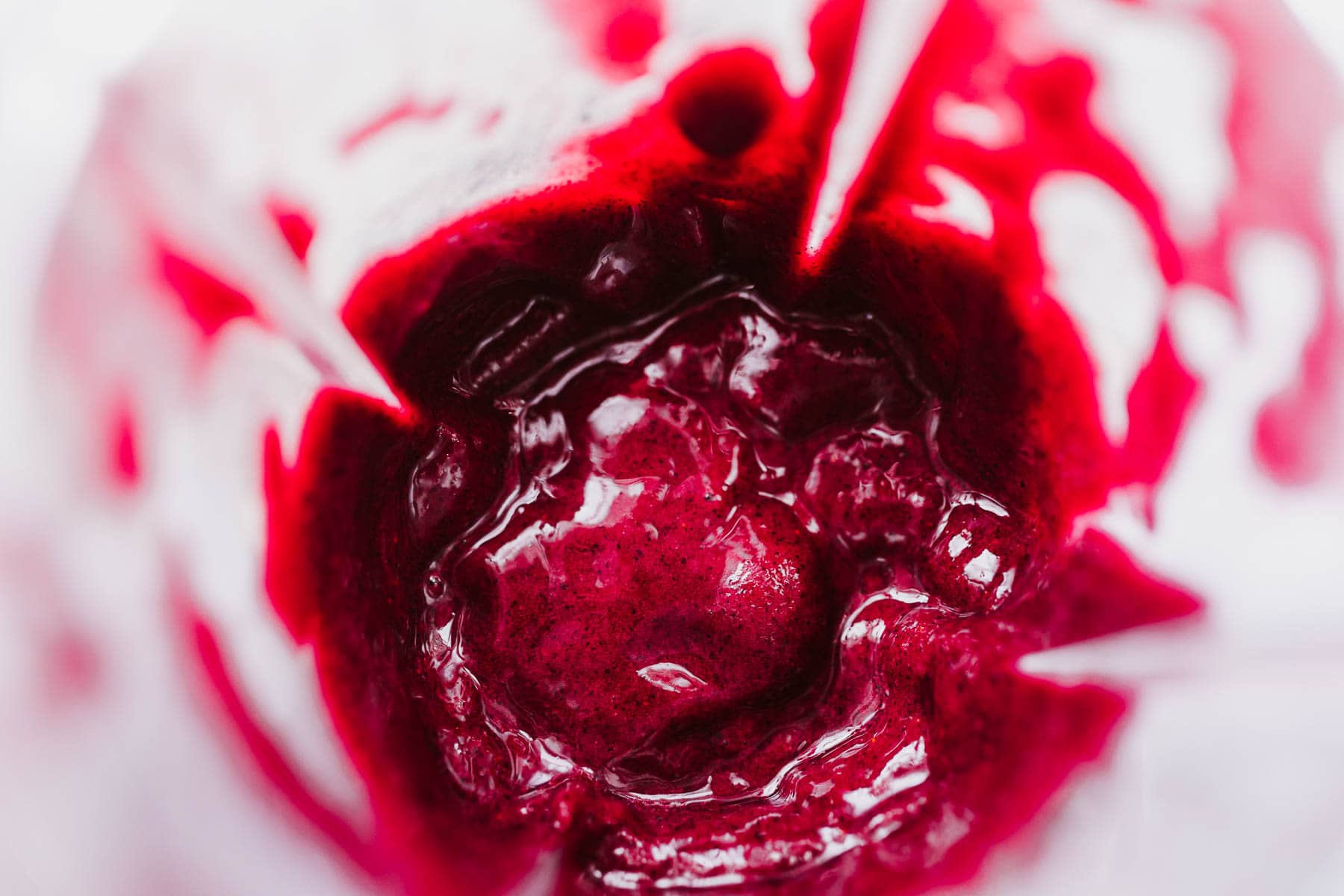 Top view of a blender container filled with a freshly blended virgin blueberry margarita.