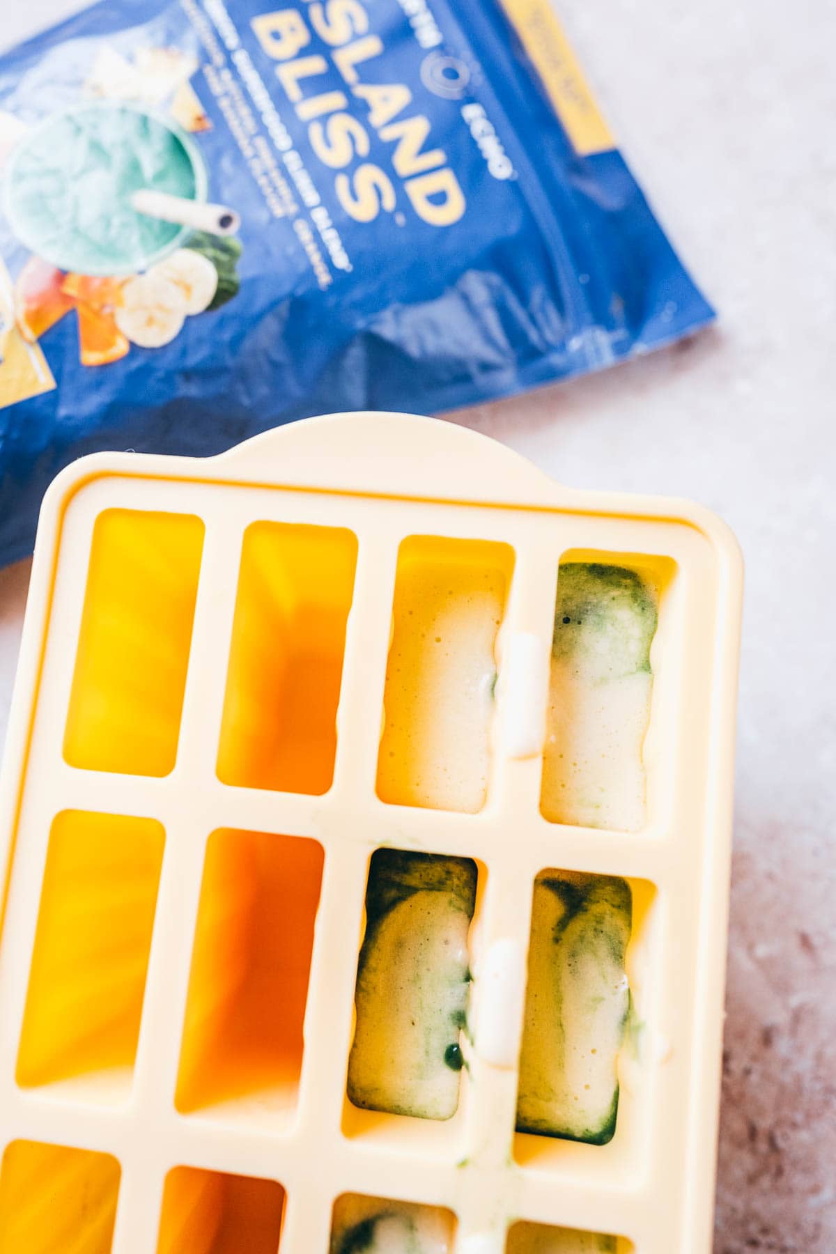 A popsicle mold filled with homemade blended popsicle ingredients.