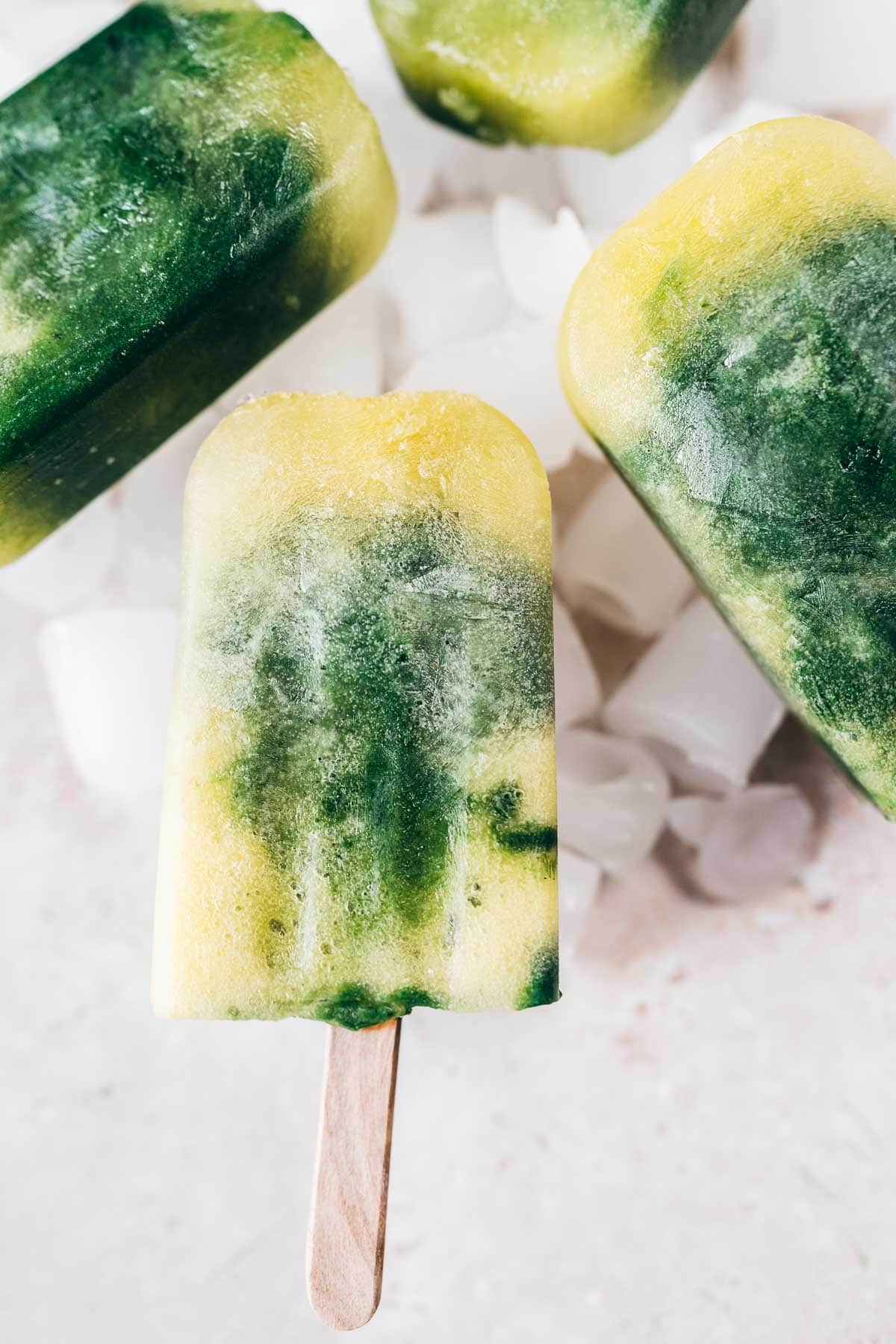 Close shot of a yellow and green popsicle.