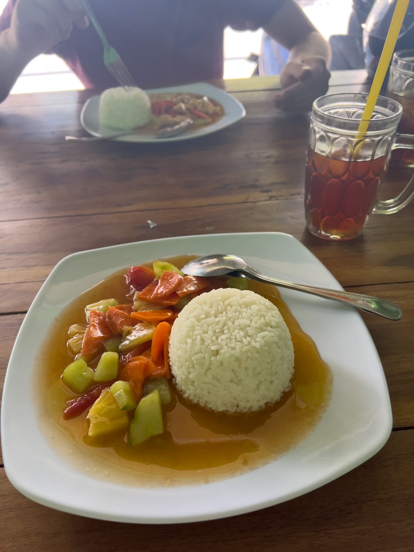 A plate of rice and vegetables at a restaurant in Indonesia.