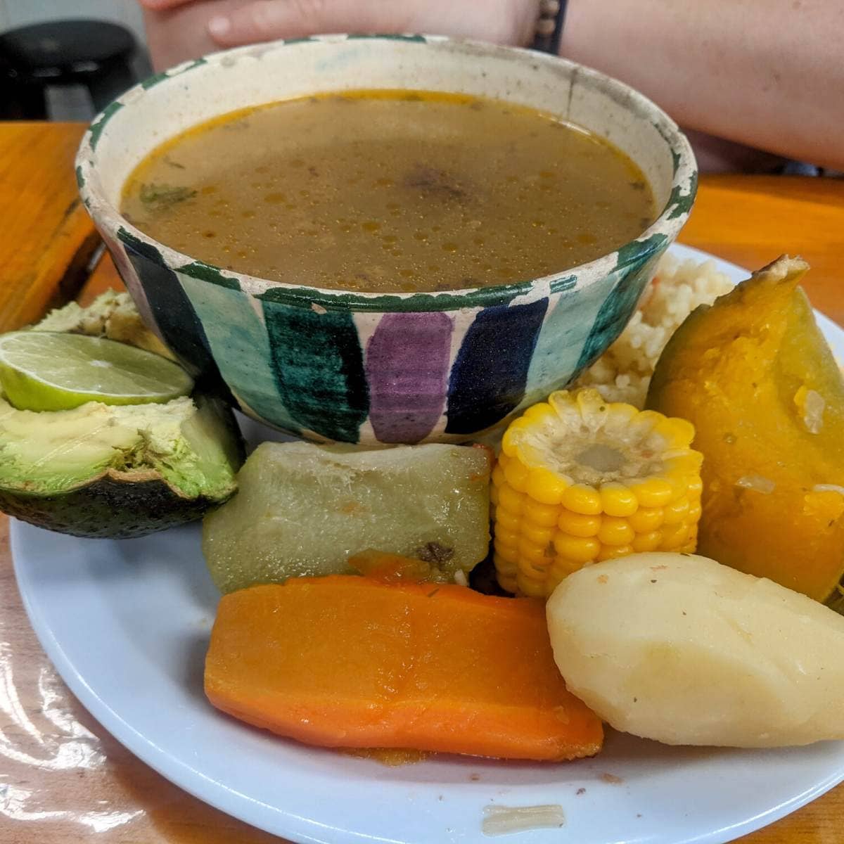 A bowl of soup surrounded by cooked vegetables in Guatemala.