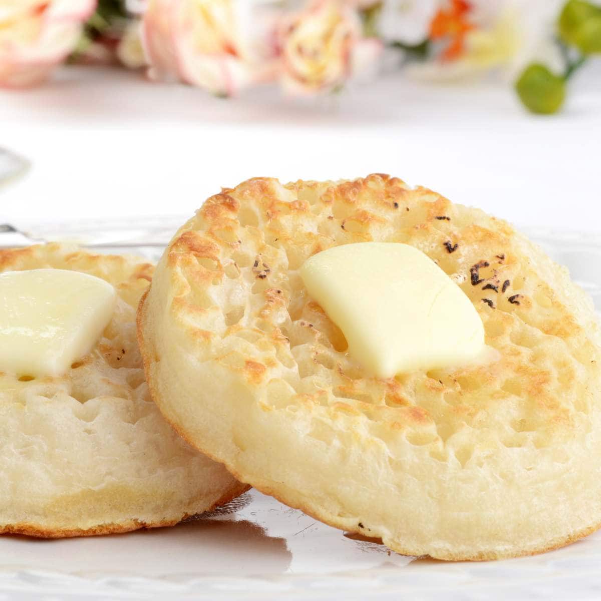 Crumpets topped with pats of butter.