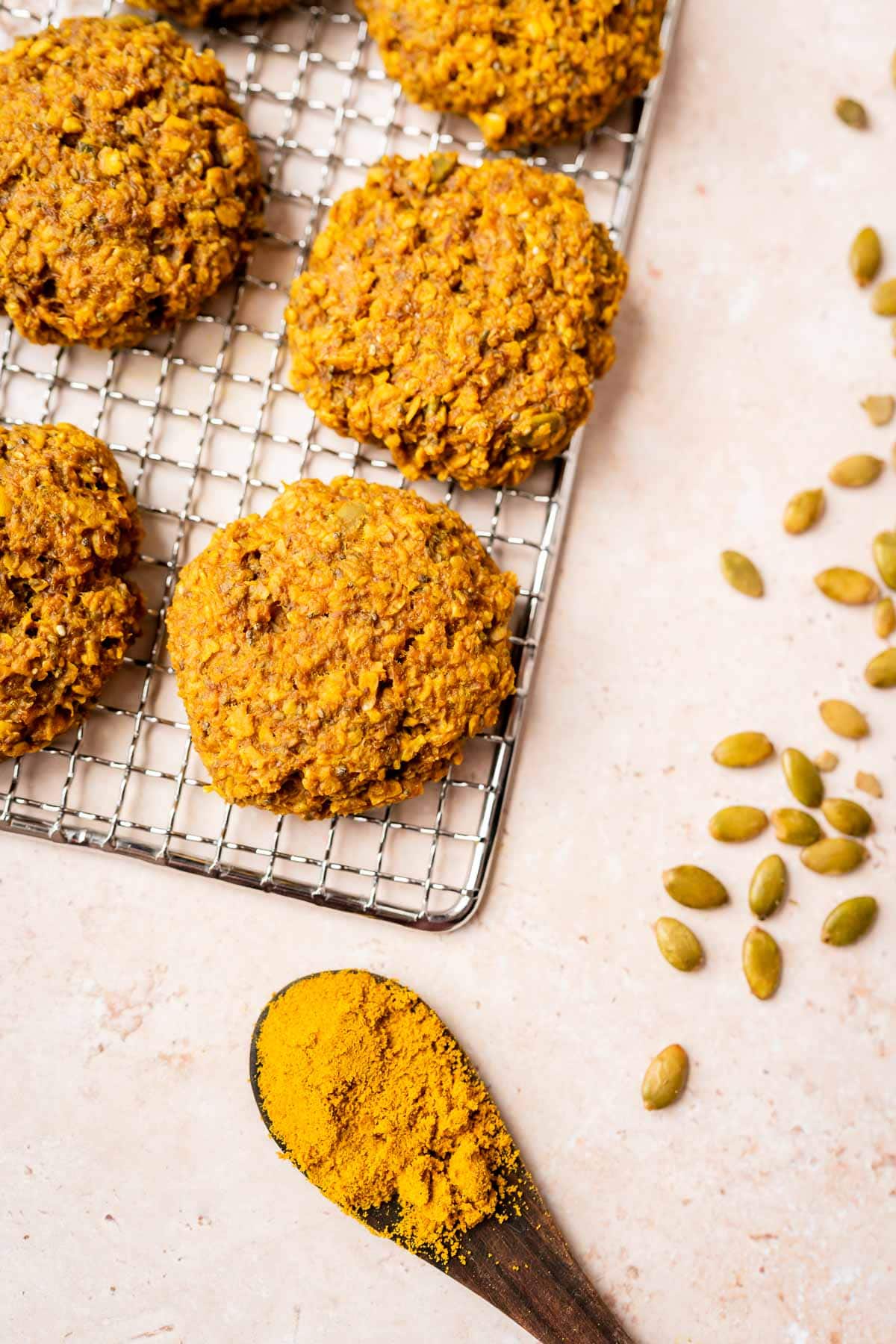 Golden milk breakfast recipe: Tumeric oat cookies on a cooling rack with a spoon.