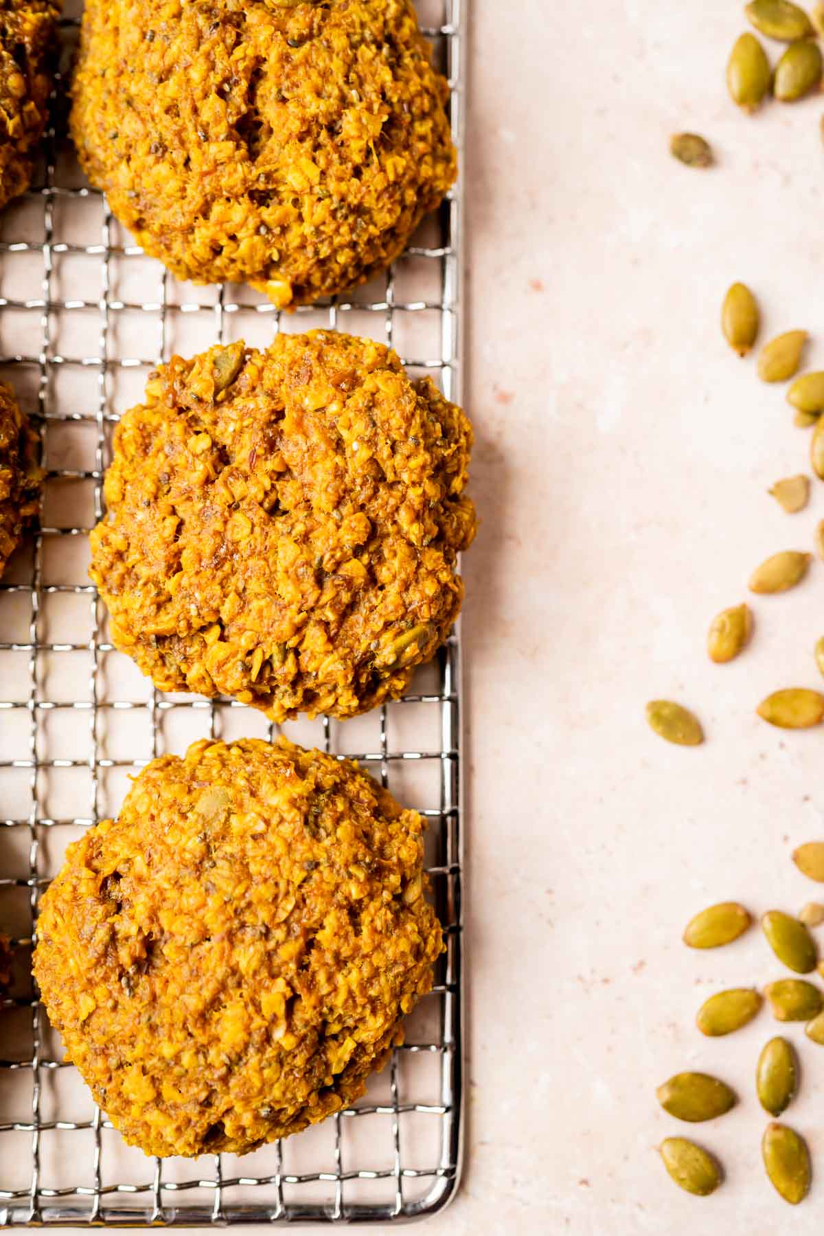 Golden milk pumpkin seeds and oats on a cooling rack.