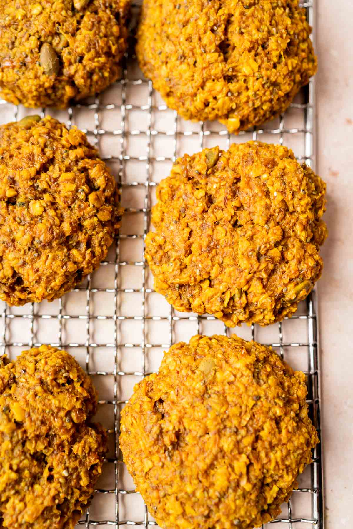 Golden quinoa cookies on a cooling rack.