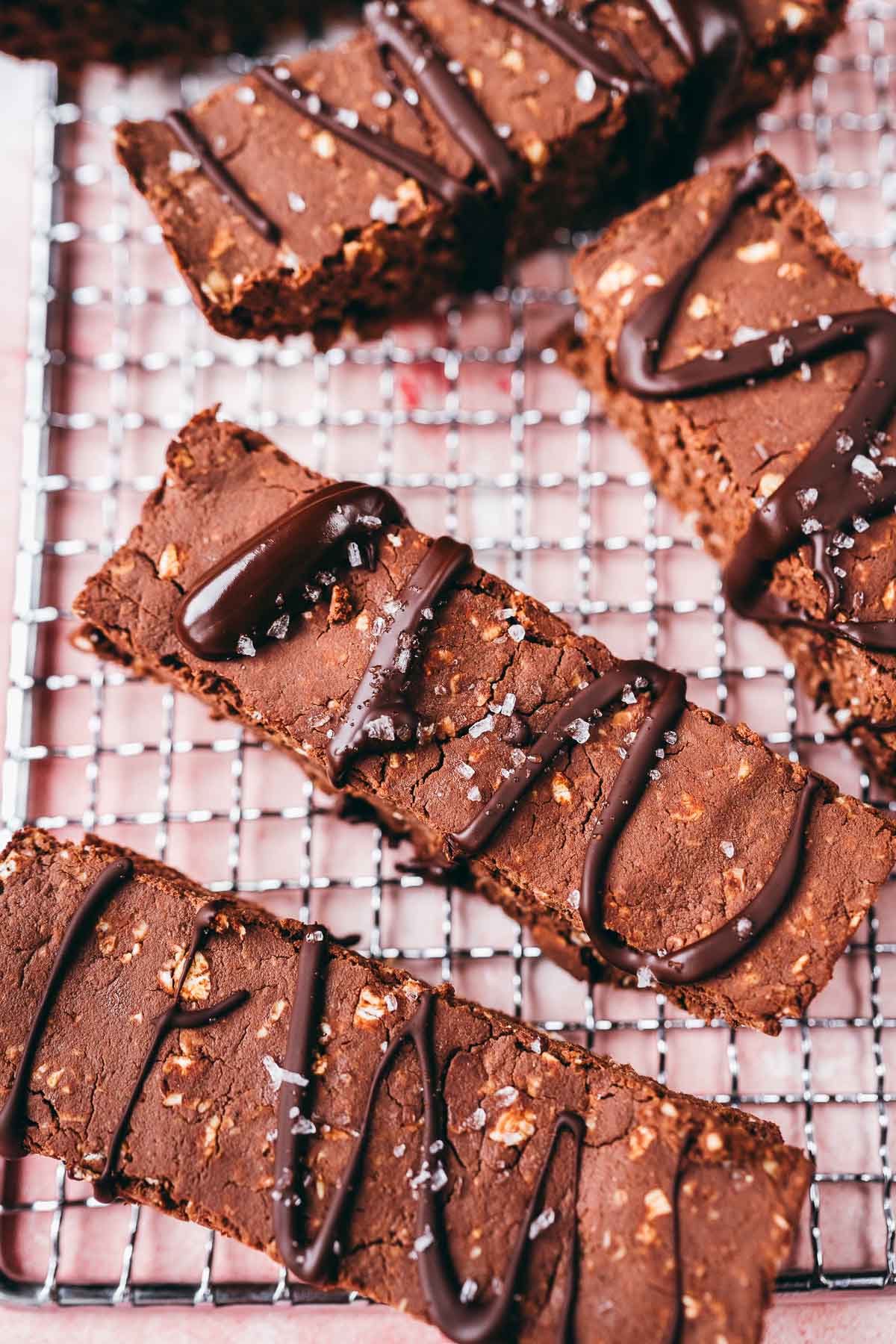 Mocha protein bars resting on a silver cooling rack.