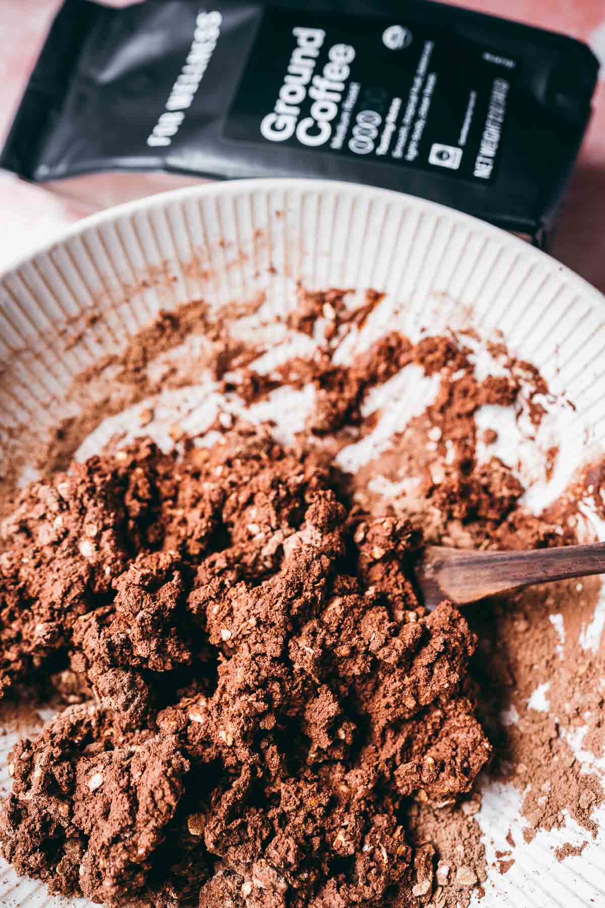 A large tan ceramic bowl filled with a chocolate protein bar batter.