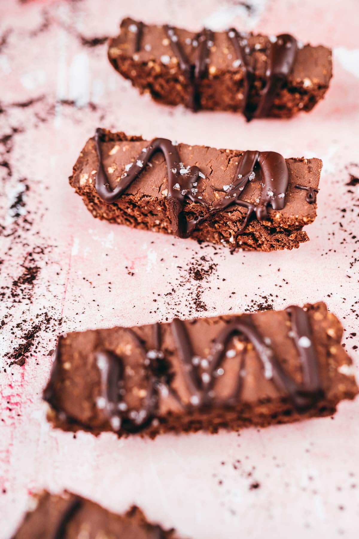 Sliced mocha bars resting on a pink table.