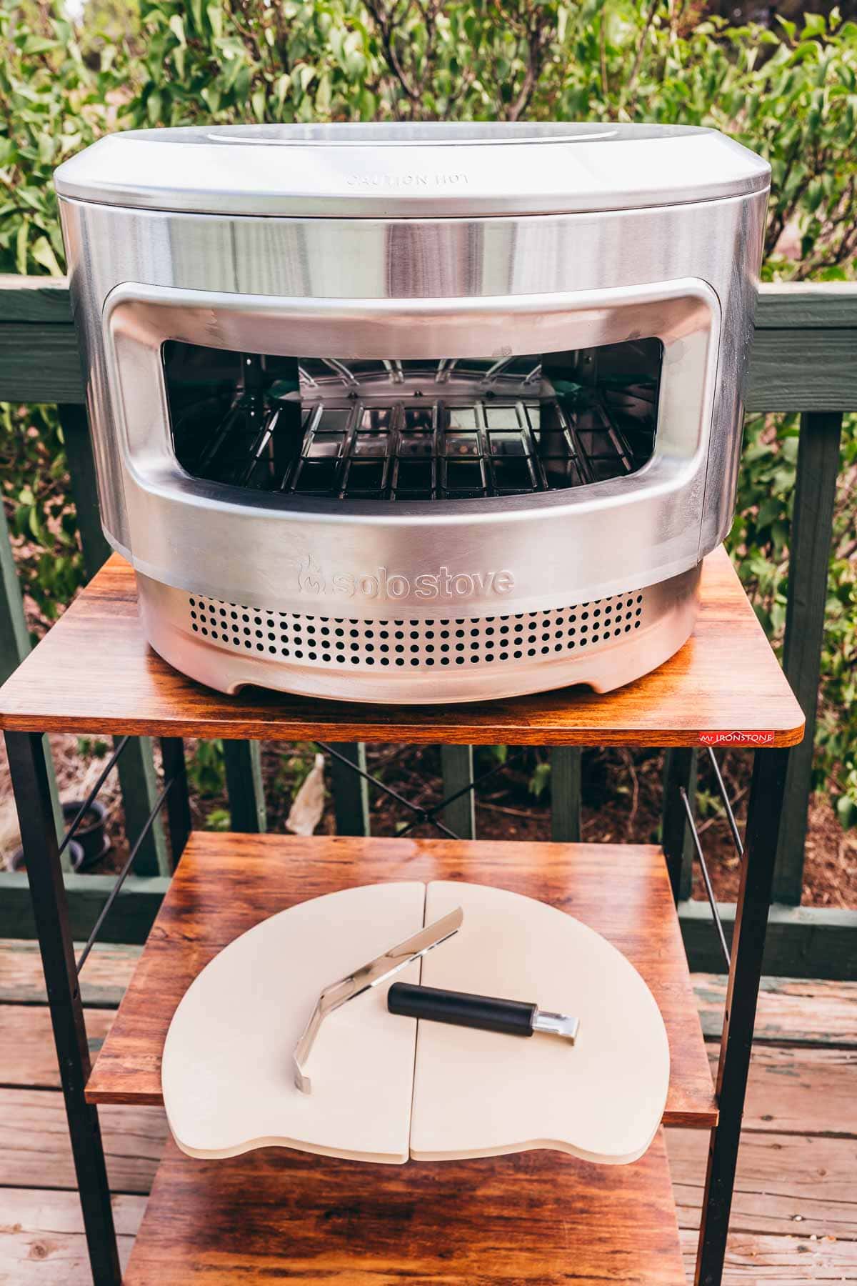 A Solo Stove pizza oven on a wooden table.