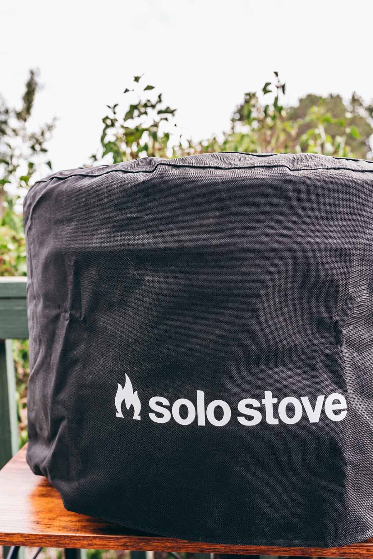 A black bag with white text featuring a solo stove pizza oven.