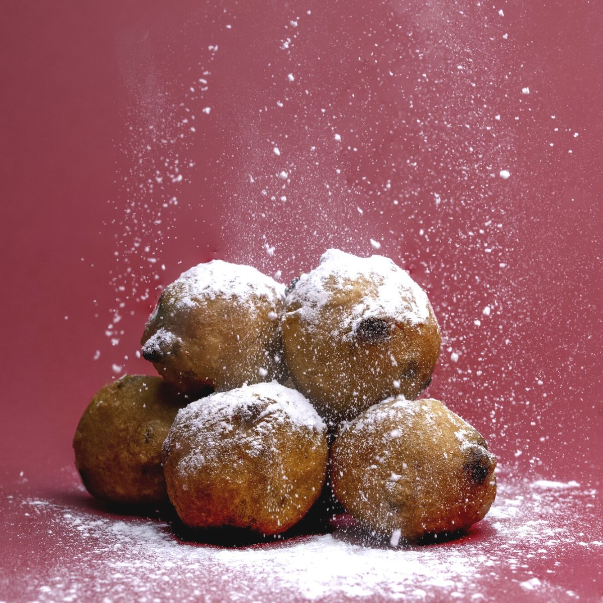 Vegetarian Dutch donuts on a red background.