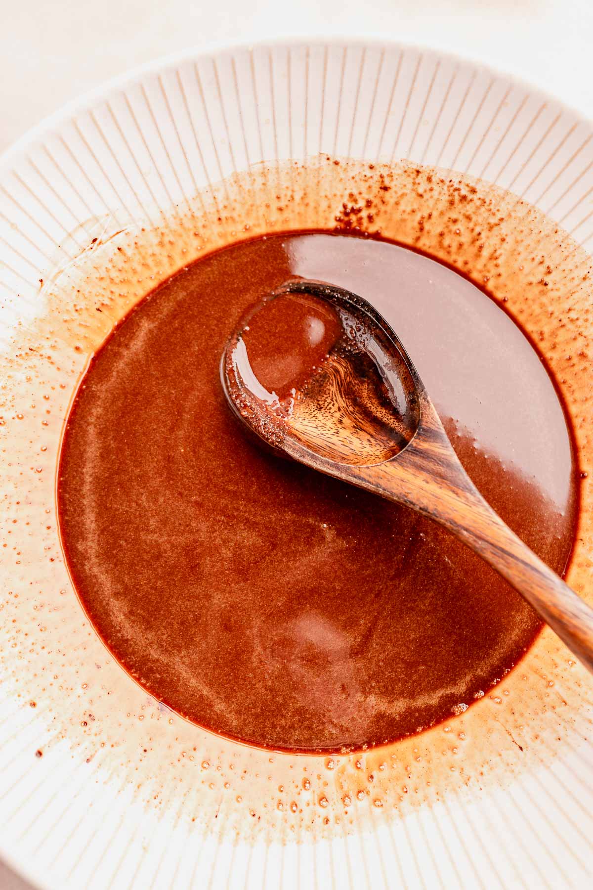 A bowl of chocolate sauce with almond butter.