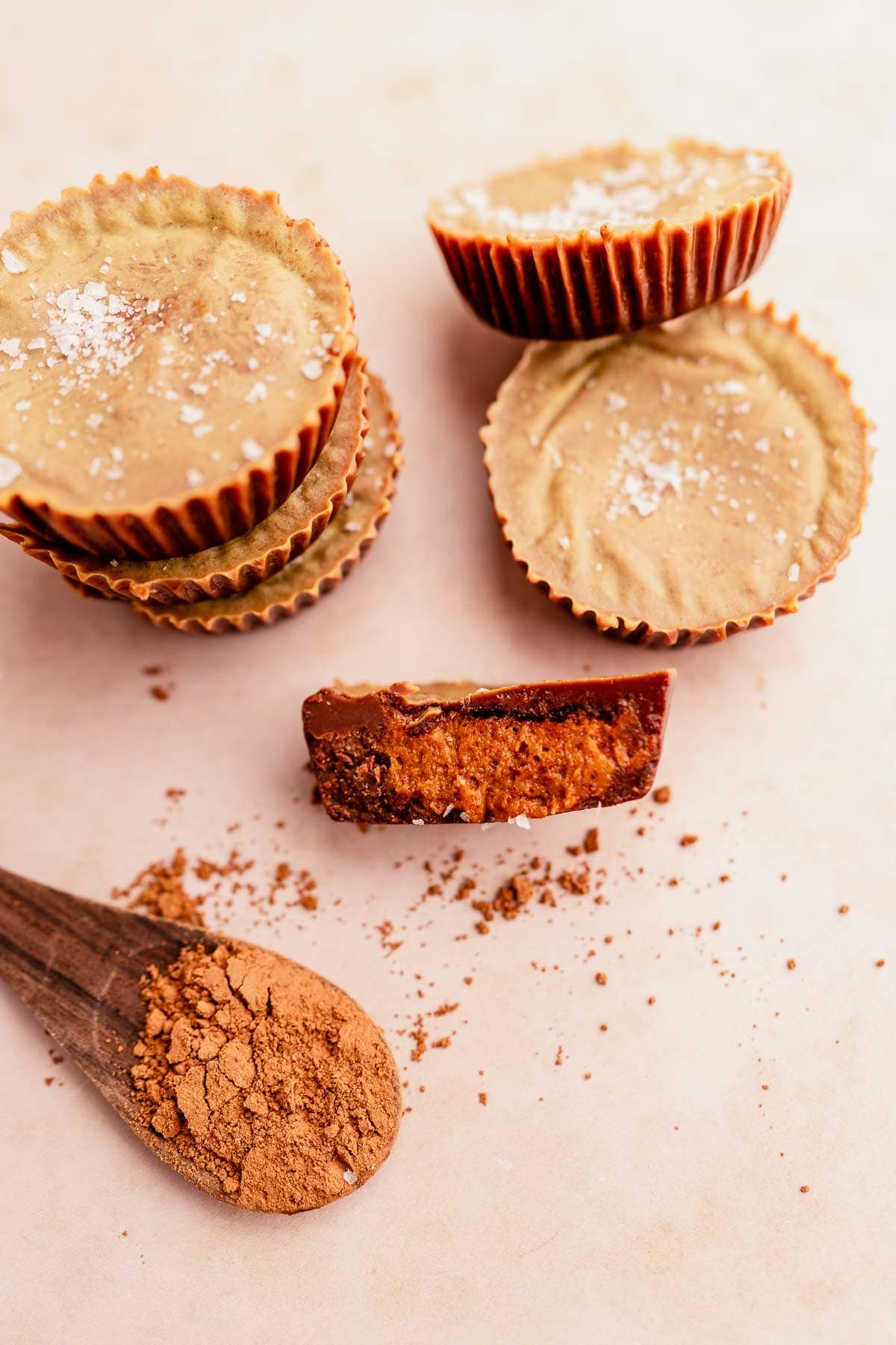 Chocolate almond butter cups with a spoon next to them.