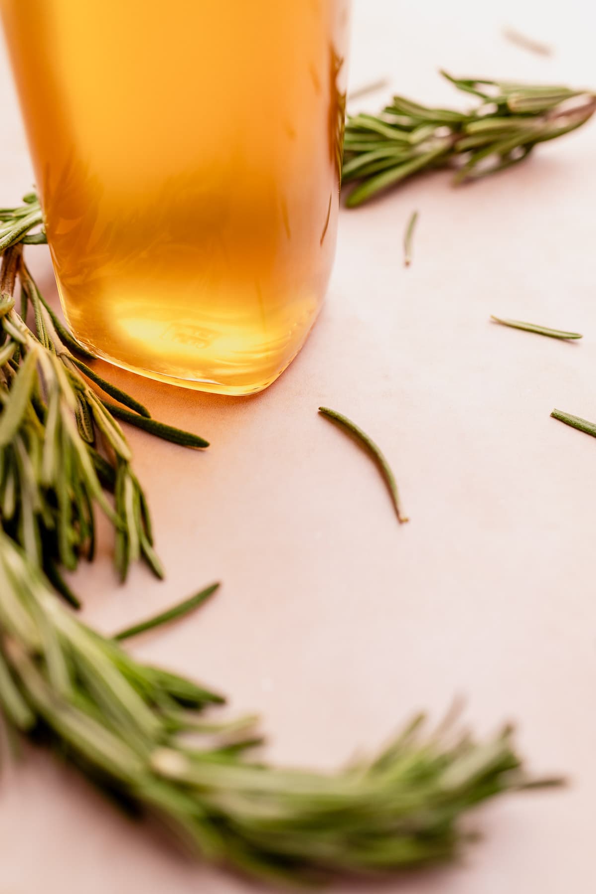 A glass of rosemary-infused honey.
