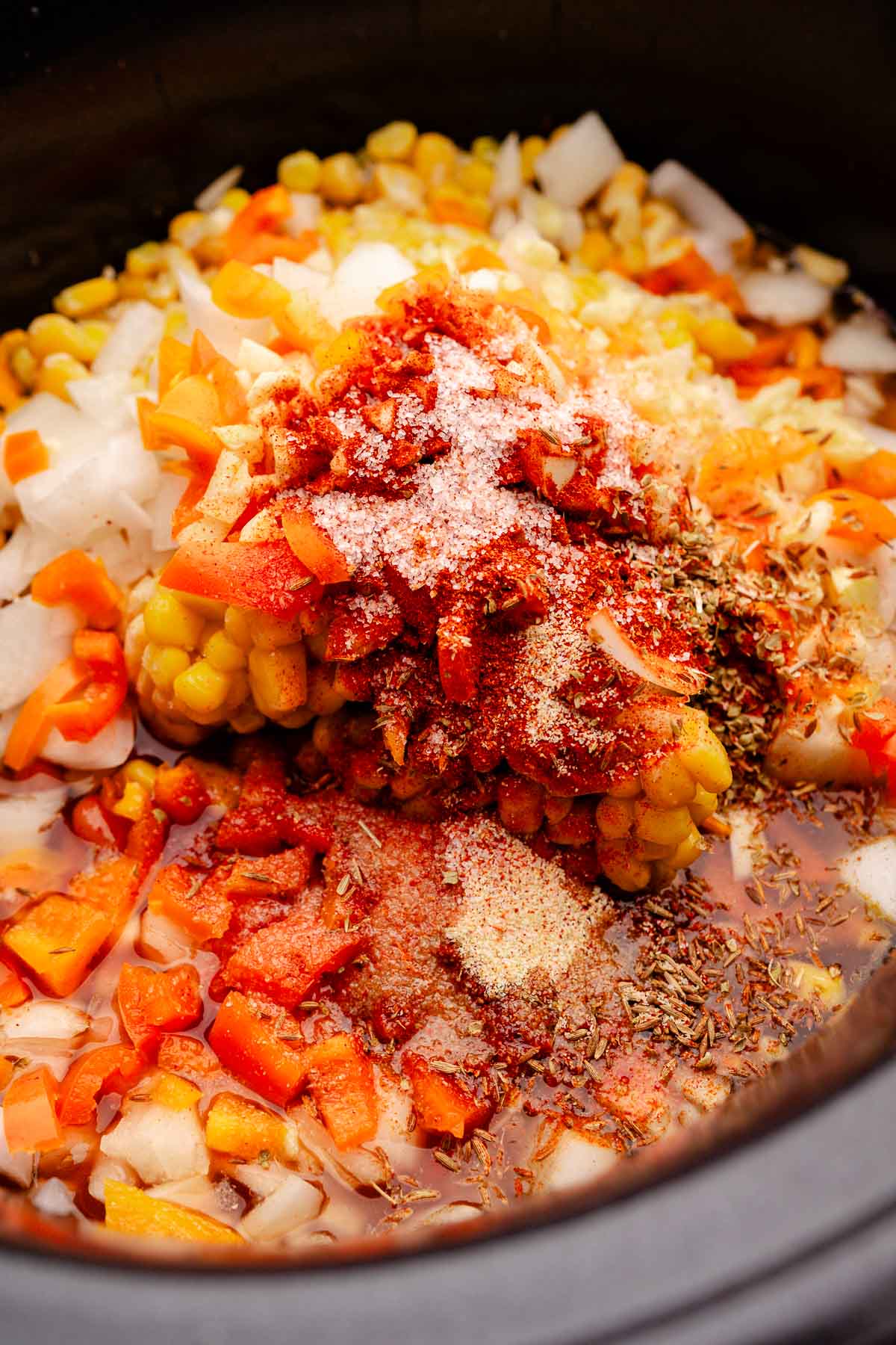 A slow cooker vegetarian chili filled with vegetables and spices.