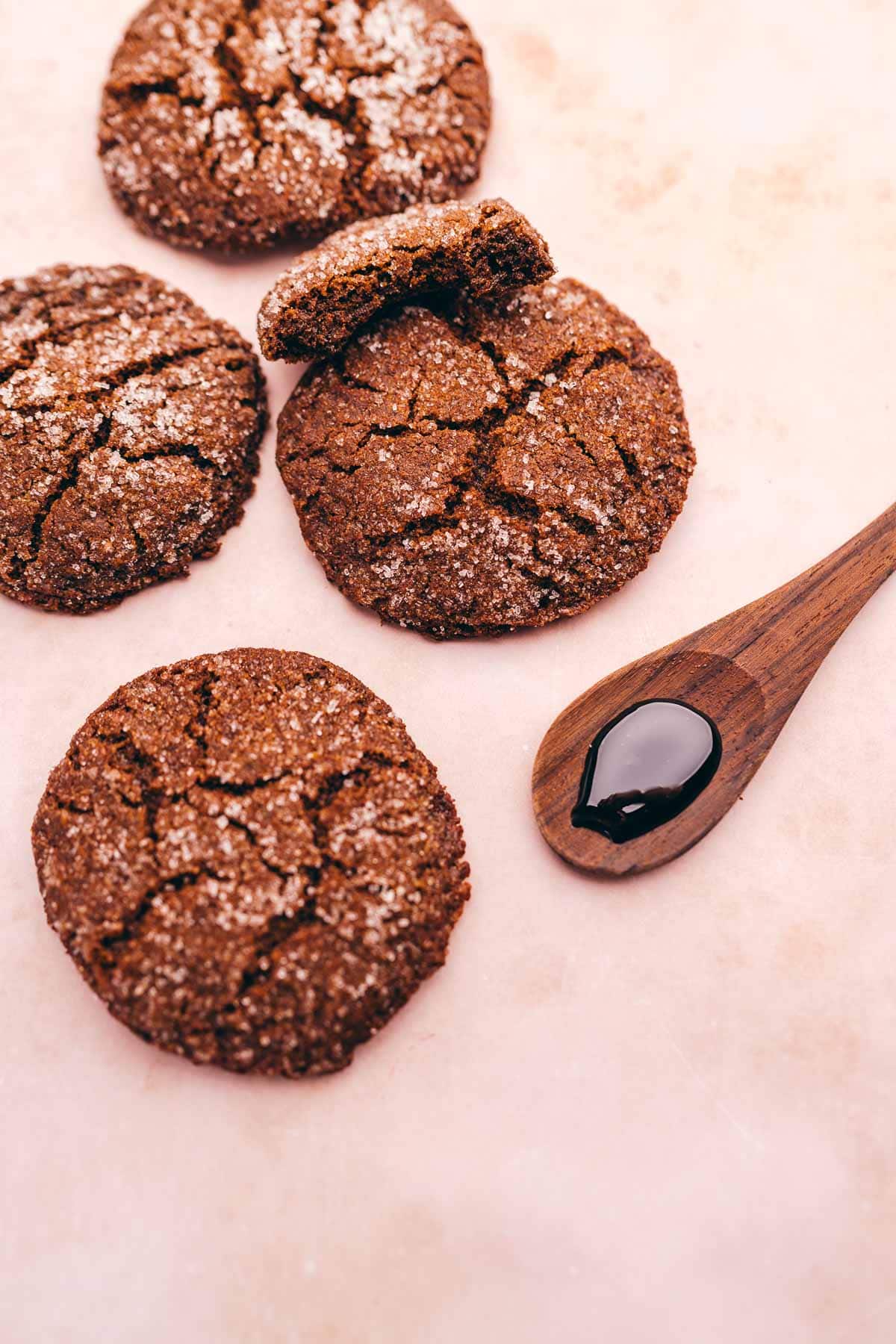 Gingerbread gluten free cookies with a wooden spoon on a pink background.