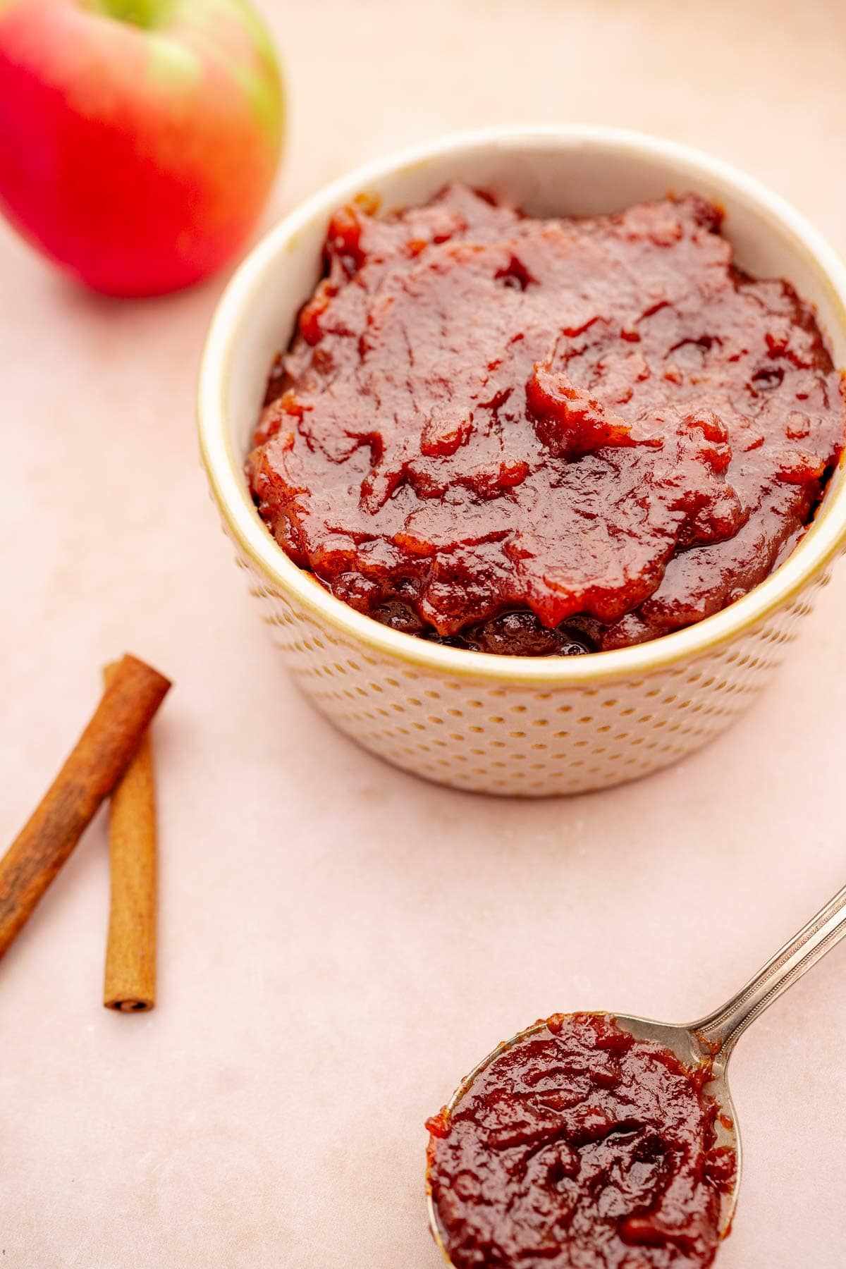 Apple sauce with cinnamon sticks simmered in a slow cooker.