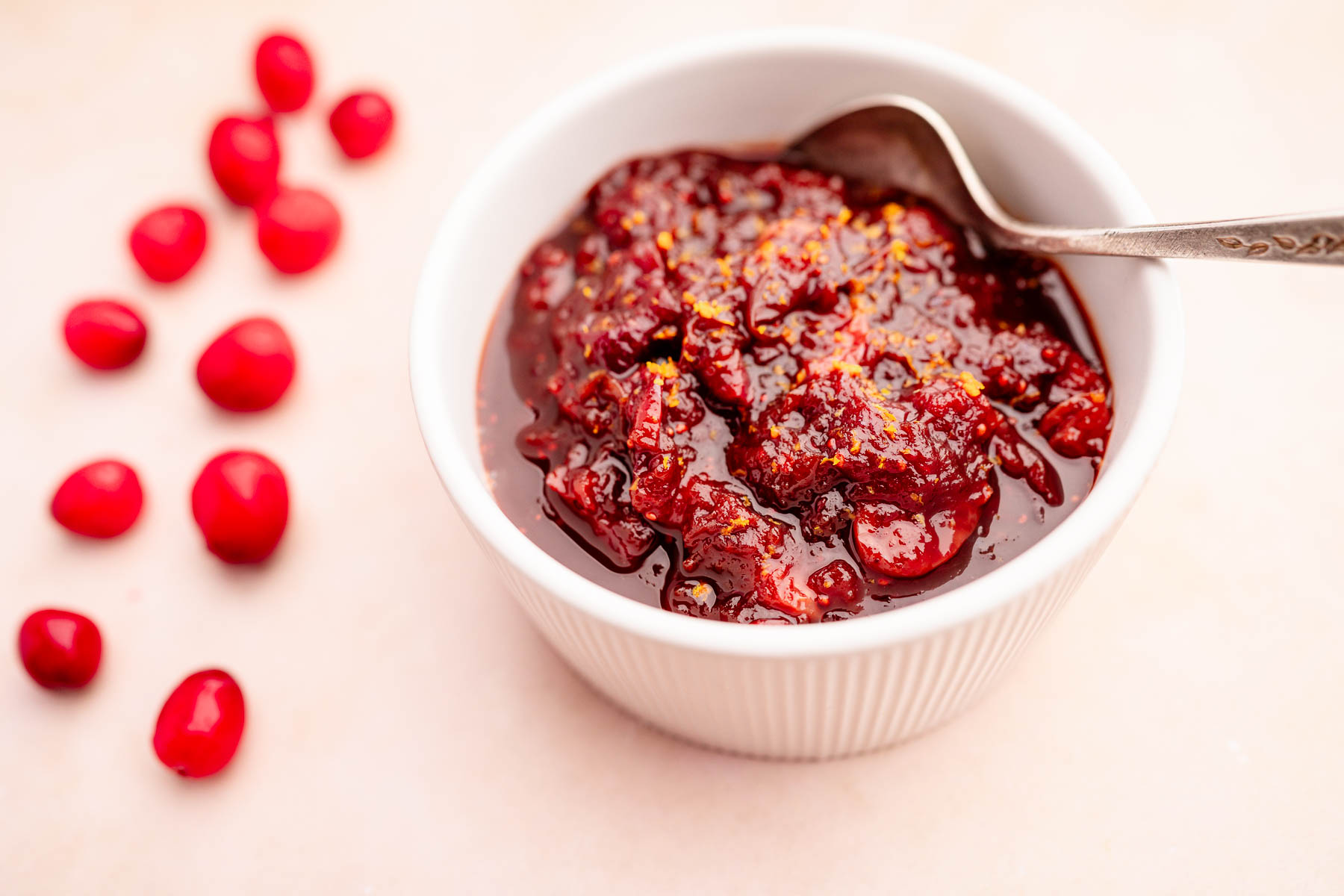 Slow cooker cranberry sauce in a white bowl.