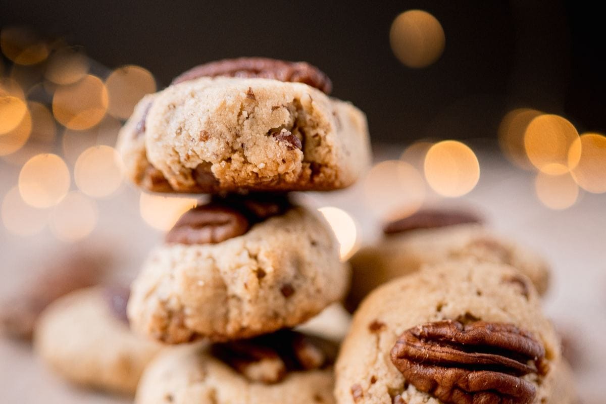 Gluten-free pecan sandies stacked on top of each other.