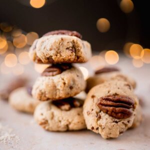Pecan cookies stacked on top of each other.
