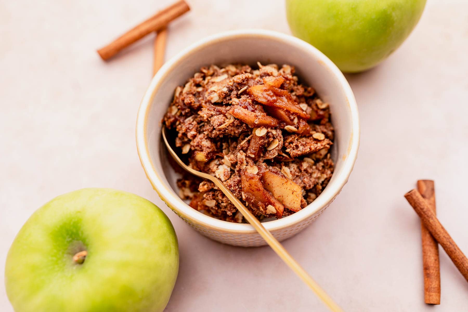 A gluten-free bowl of granola with apples and cinnamon.