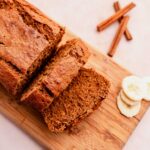 A slice of oat flour banana bread on a cutting board.