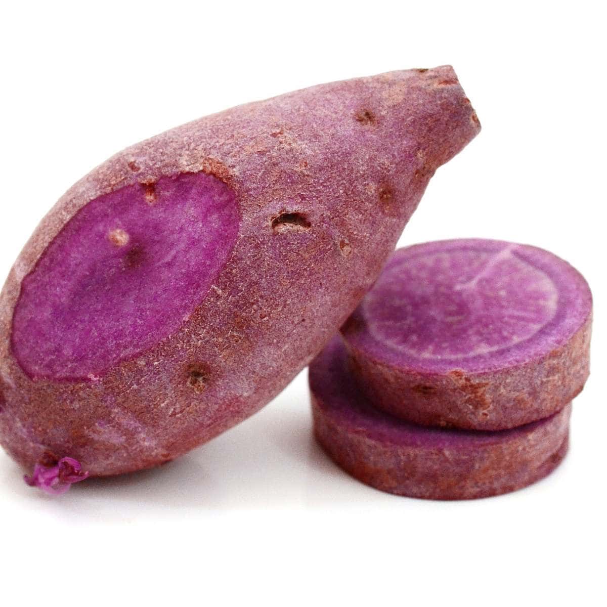 A purple sweet potato on a white background.