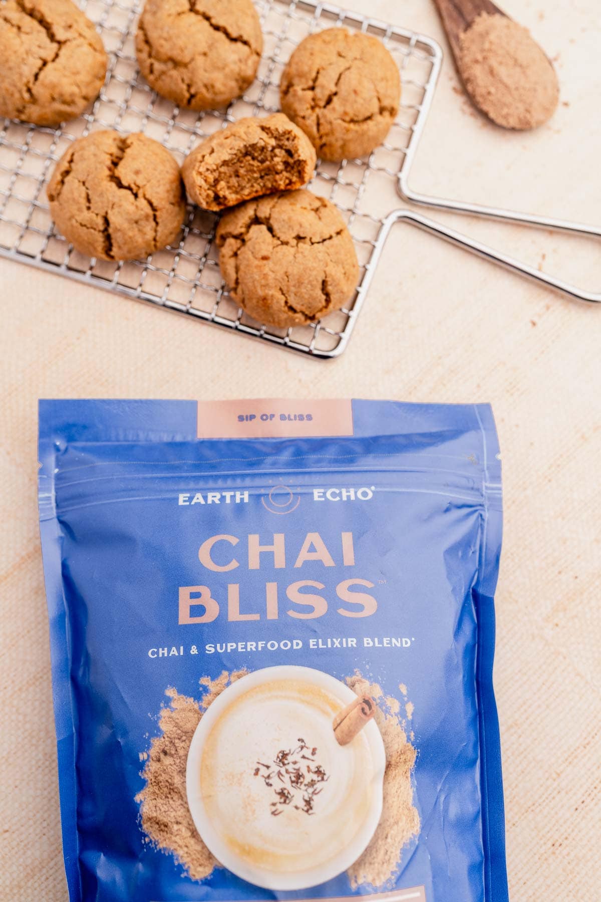           A bag of ginger chai cookies next to a cup of coffee.
