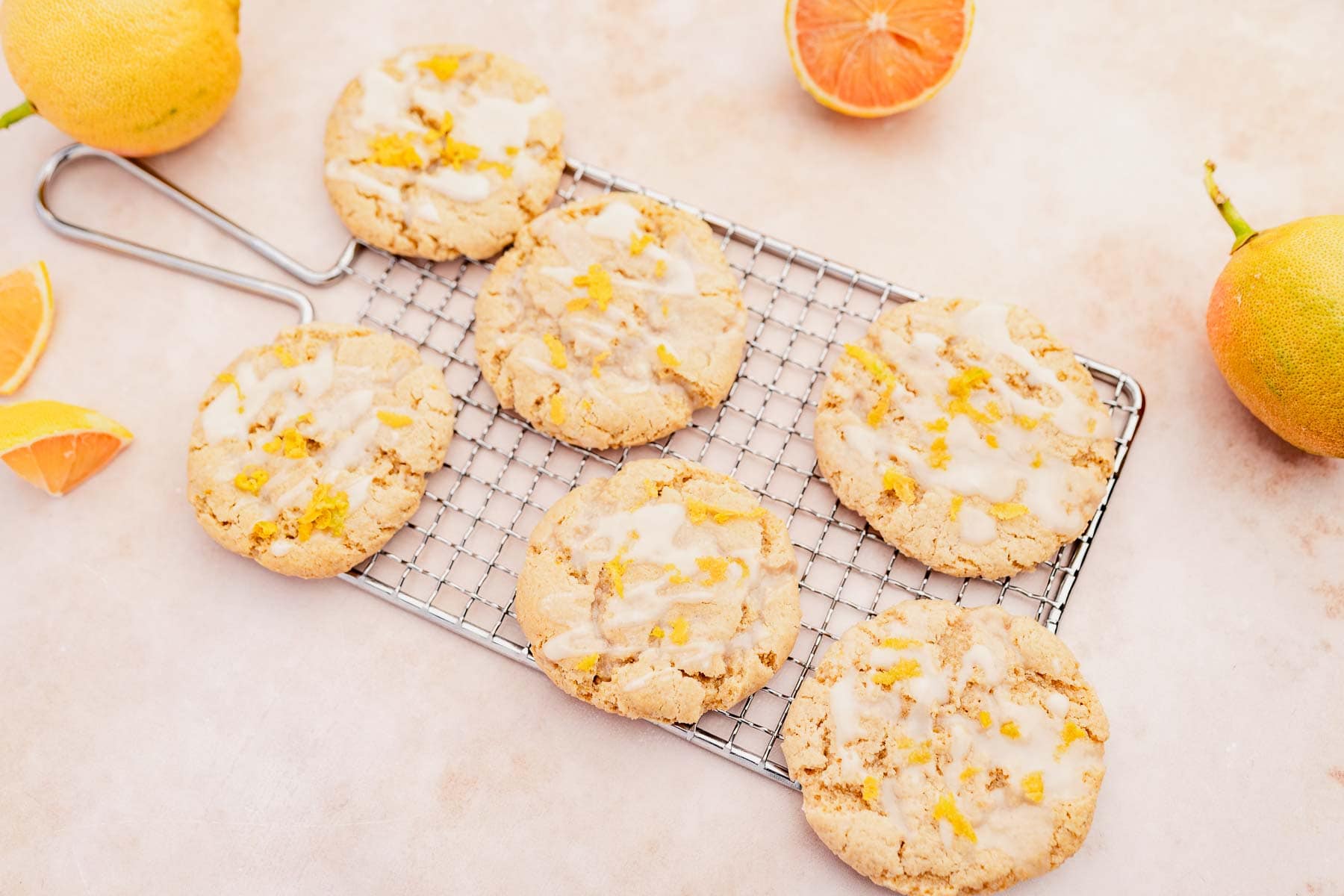 Gluten-free orange glazed cookies on a cooling rack.