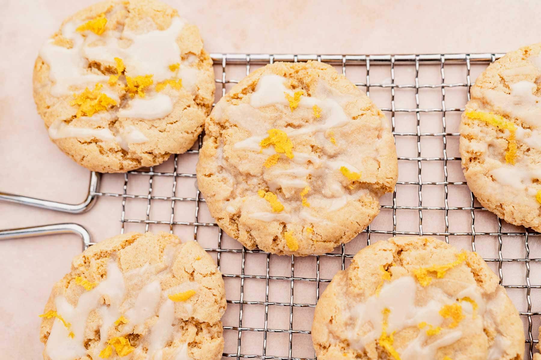 Gluten-free lemon icing cookies on a cooling rack.