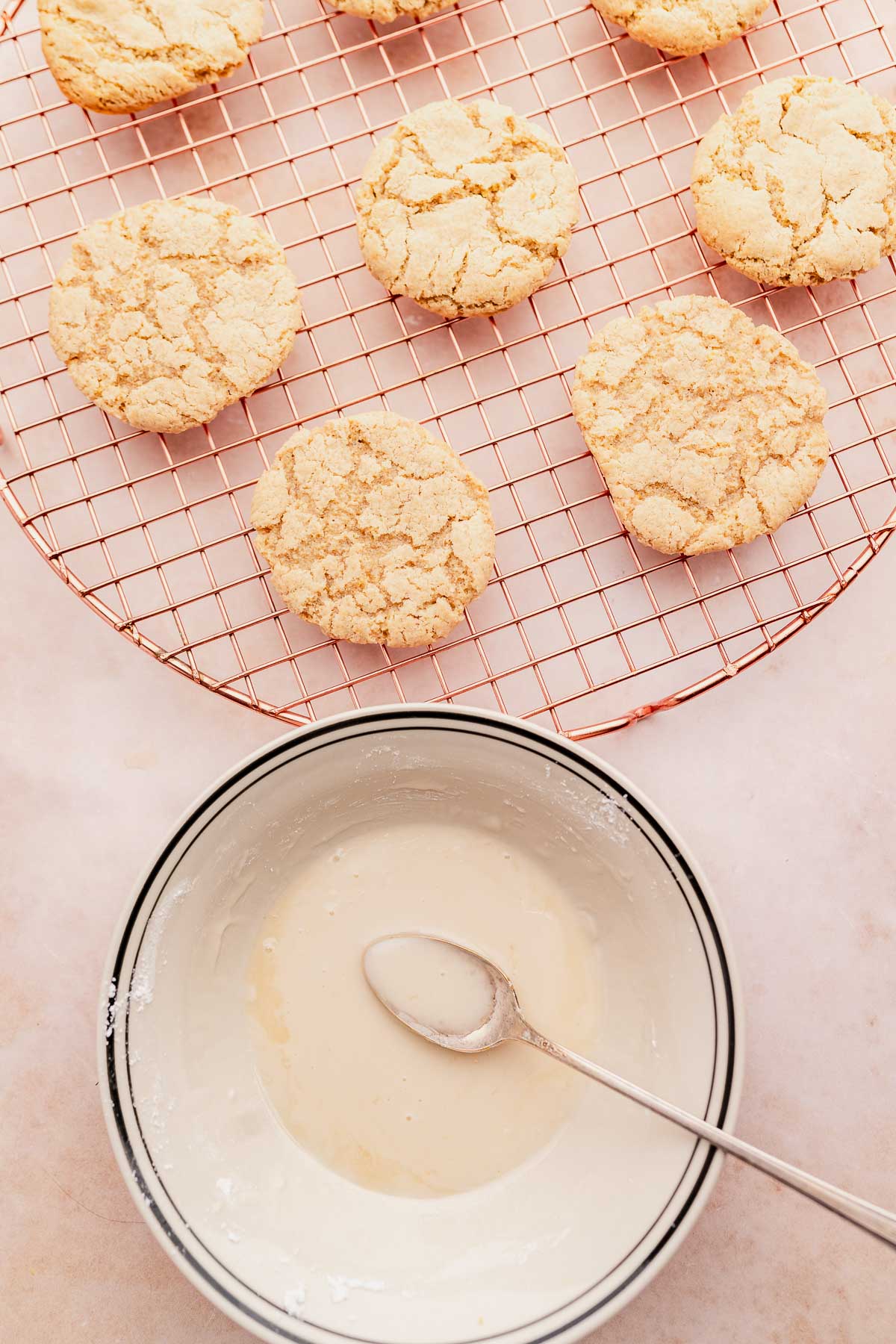 A bowl of gluten free lemon cookies with a spoon next to it.