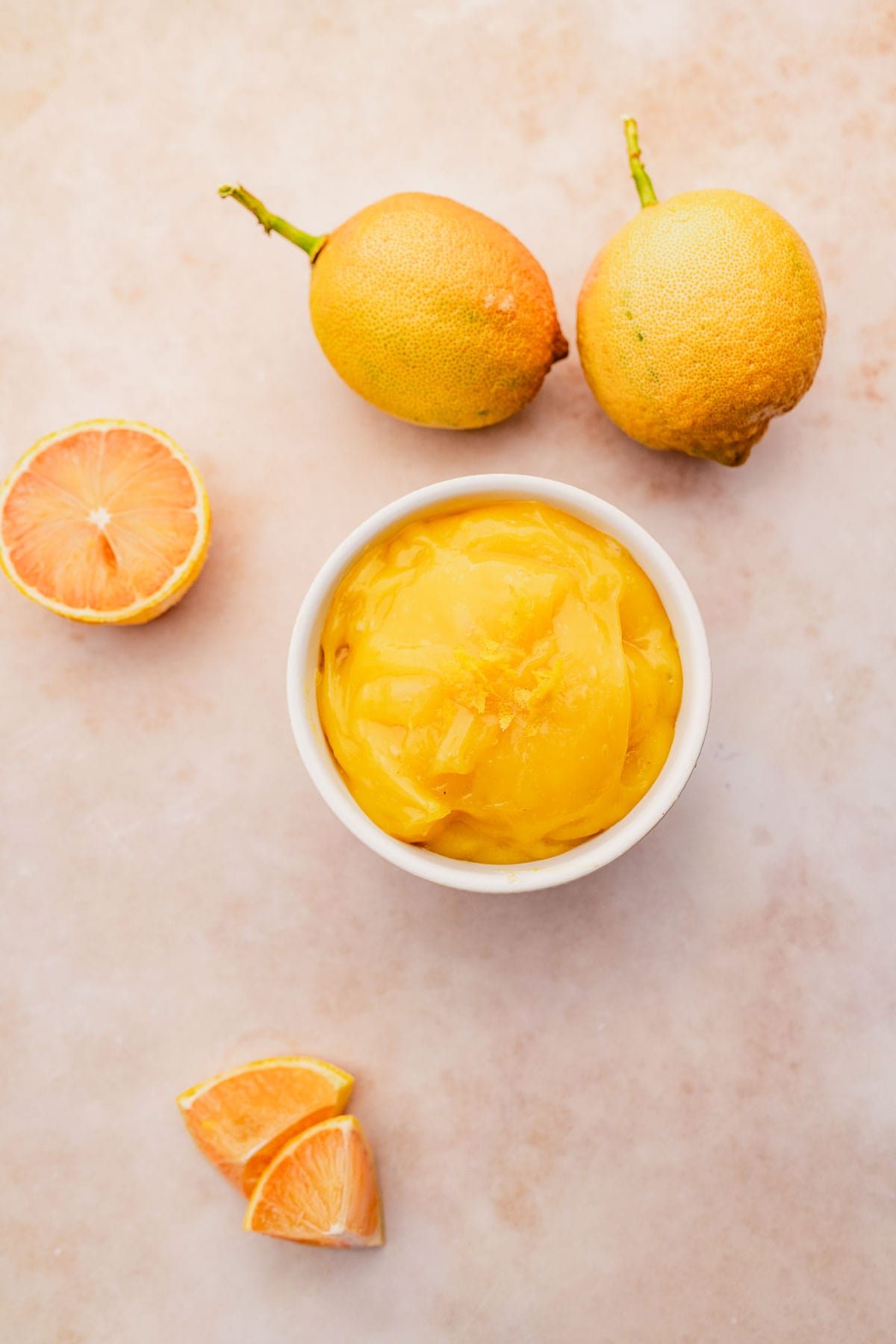 A bowl of vegan orange marmalade on a table.